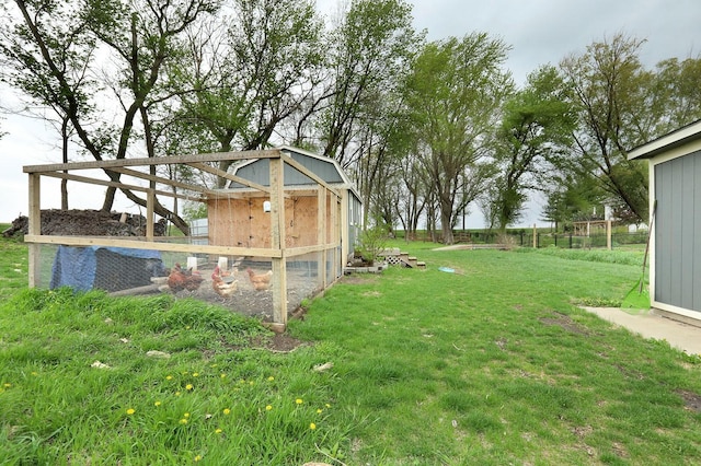 view of yard featuring exterior structure and an outbuilding