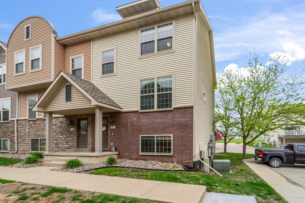 3600 SE Glenstone Dr Unit 301, Grimes, IA 50111 - multi unit property with a porch and brick siding