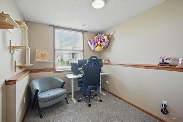 office featuring visible vents, carpet flooring, a textured ceiling, and baseboards