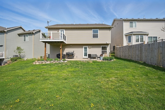 back of property featuring a yard, a patio, and fence