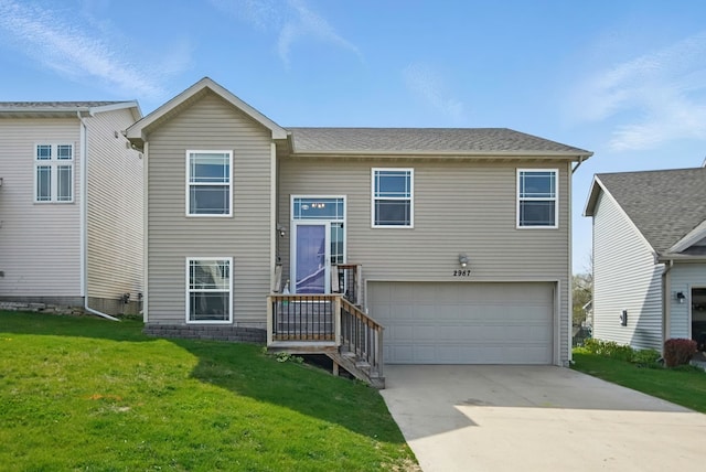 view of front of property with an attached garage, driveway, and a front yard