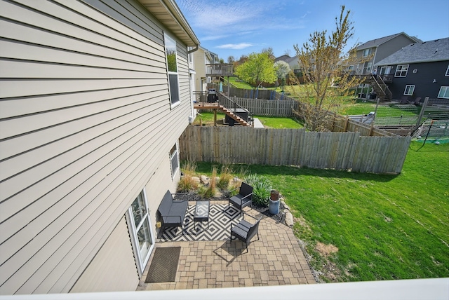 view of yard featuring a residential view, a fenced backyard, and a patio area