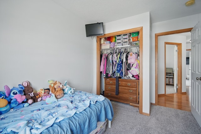 bedroom with carpet and a closet