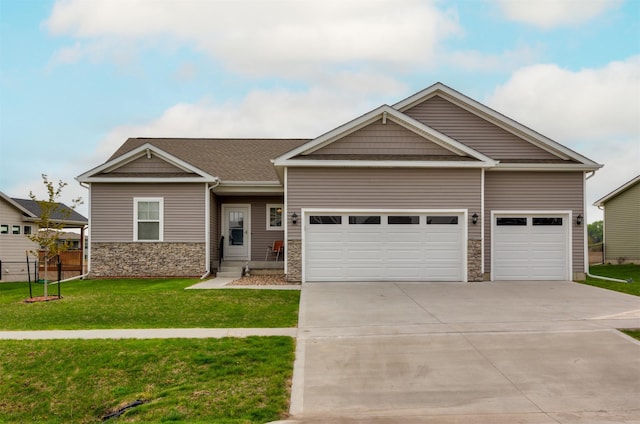 craftsman inspired home featuring a front lawn, fence, stone siding, an attached garage, and driveway