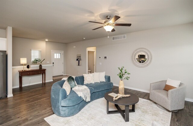 7920 NW 95th St, Johnston, IA 50131 - living room featuring dark wood-style flooring, ceiling fan, and baseboards
