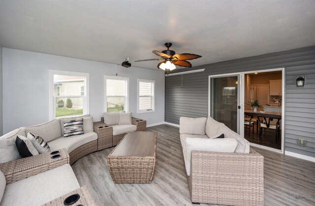 7920 NW 95th St, Johnston, IA 50131 - living area featuring light wood-style flooring, ceiling fan, and baseboards