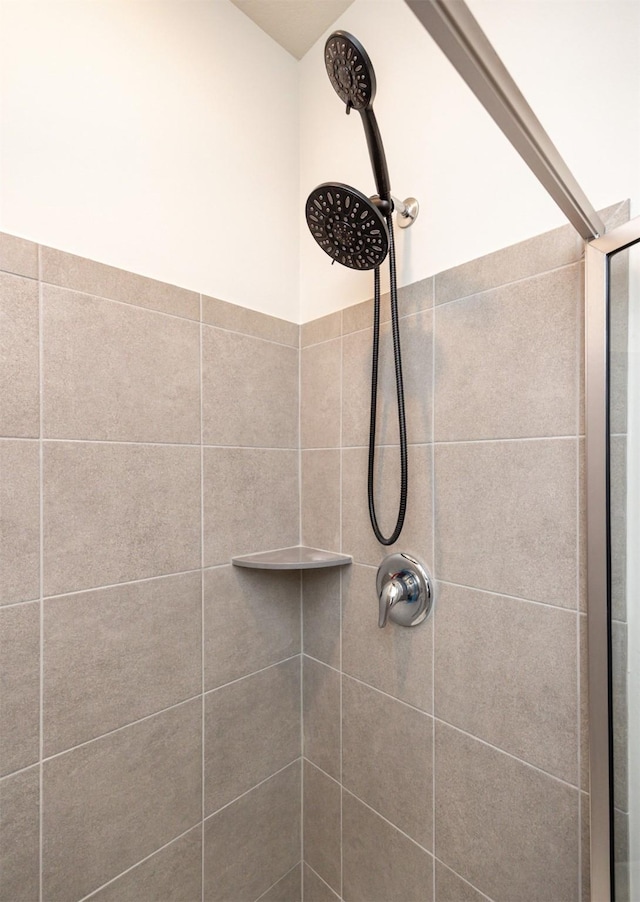 interior details with a tile shower