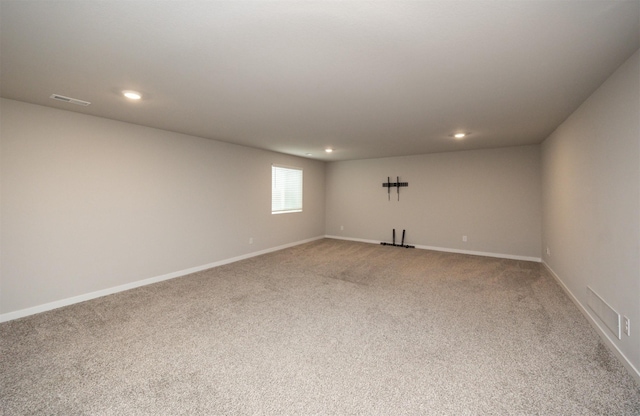 unfurnished room featuring baseboards, light carpet, and recessed lighting