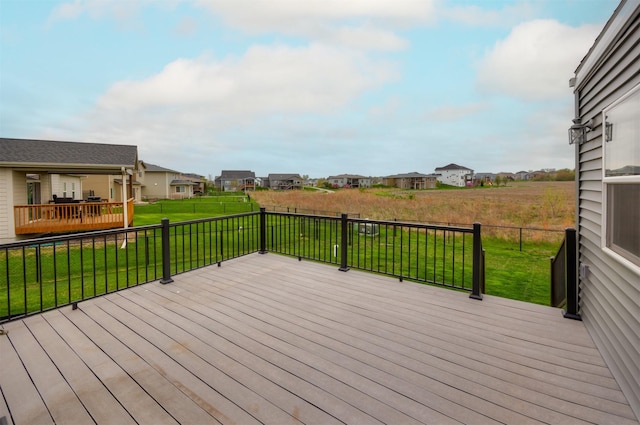 deck with a lawn, a residential view, and a fenced backyard