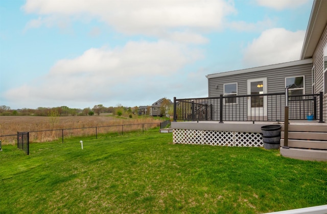 view of yard featuring fence and a wooden deck
