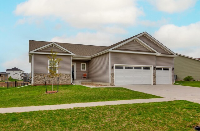 7920 NW 95th St, Johnston, IA 50131 - view of front facade featuring driveway, an attached garage, stone siding, and a shingled roof