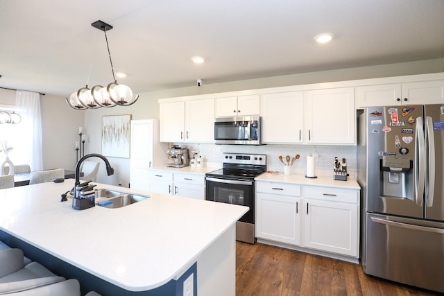 kitchen featuring a sink, white cabinetry, a kitchen bar, and stainless steel appliances