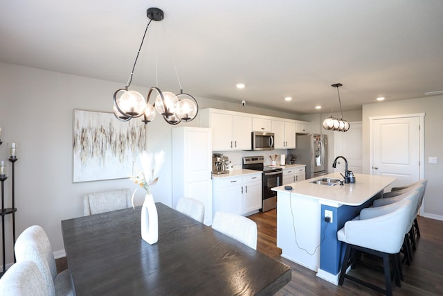 dining space with recessed lighting, baseboards, dark wood finished floors, and a chandelier