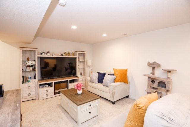 living room featuring recessed lighting and light carpet