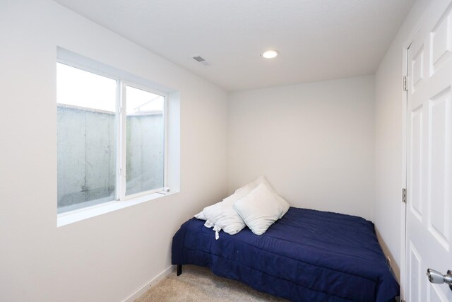 bedroom with baseboards, recessed lighting, visible vents, and light carpet