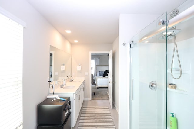 bathroom with ensuite bath, a sink, and a stall shower