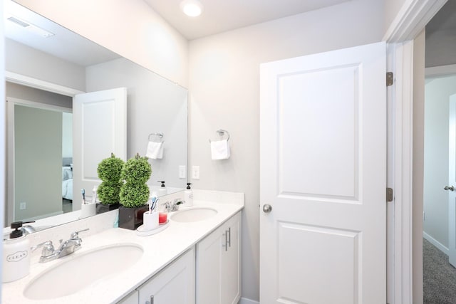 full bathroom with double vanity, visible vents, a sink, and ensuite bath