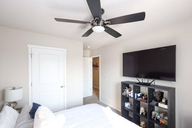 carpeted bedroom with baseboards and a ceiling fan
