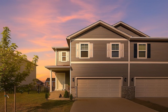 270 NW Charlestown Ln, Waukee, IA 50263 - view of front of home featuring a garage, stone siding, and concrete driveway