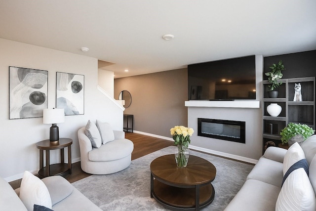 270 NW Charlestown Ln, Waukee, IA 50263 - living area featuring wood finished floors and a glass covered fireplace