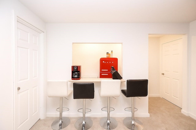 270 NW Charlestown Ln, Waukee, IA 50263 - bar featuring baseboards and light carpet