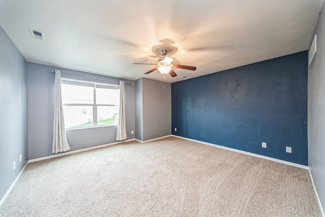 empty room with carpet floors, ceiling fan, and baseboards