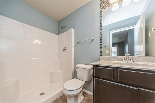 full bath with vanity, walk in shower, tile patterned floors, and toilet