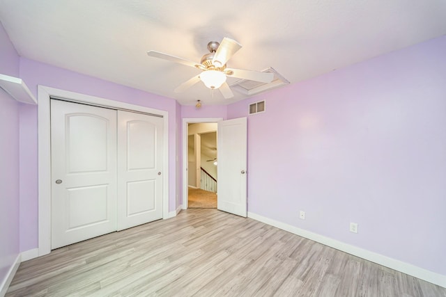 unfurnished bedroom featuring visible vents, light wood finished floors, baseboards, and a closet