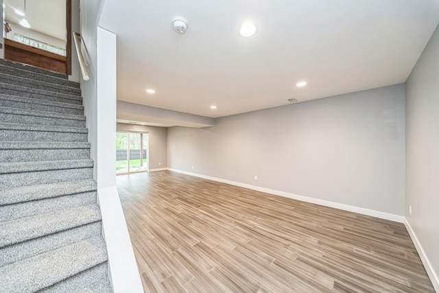 below grade area with recessed lighting, baseboards, and light wood-type flooring