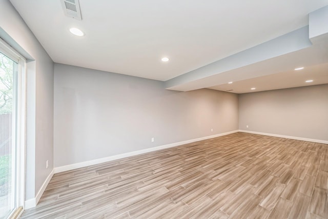 below grade area featuring baseboards, recessed lighting, light wood-style flooring, and visible vents