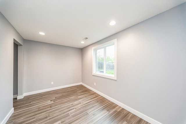 empty room with recessed lighting, baseboards, visible vents, and light wood-type flooring