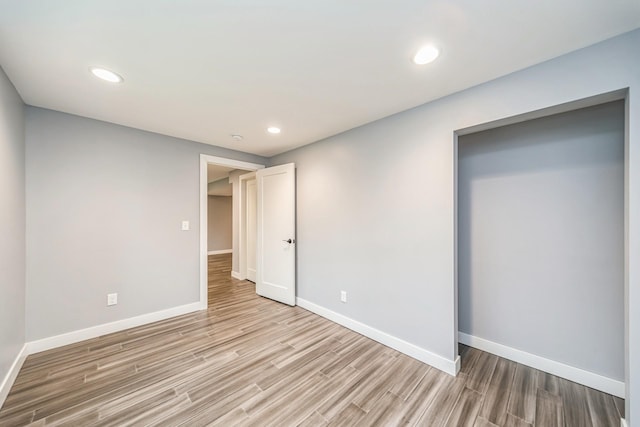 unfurnished bedroom with baseboards and light wood finished floors