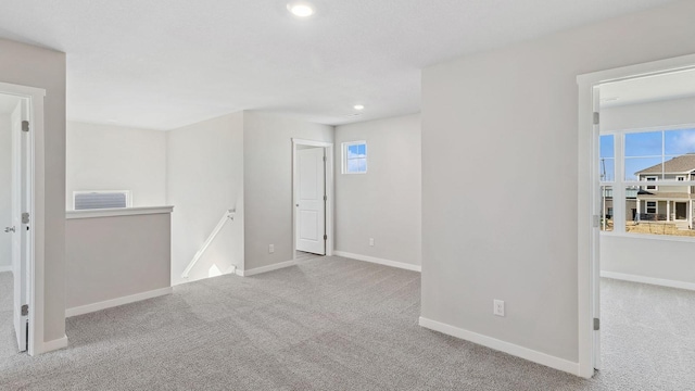 unfurnished room with carpet floors, baseboards, recessed lighting, and visible vents