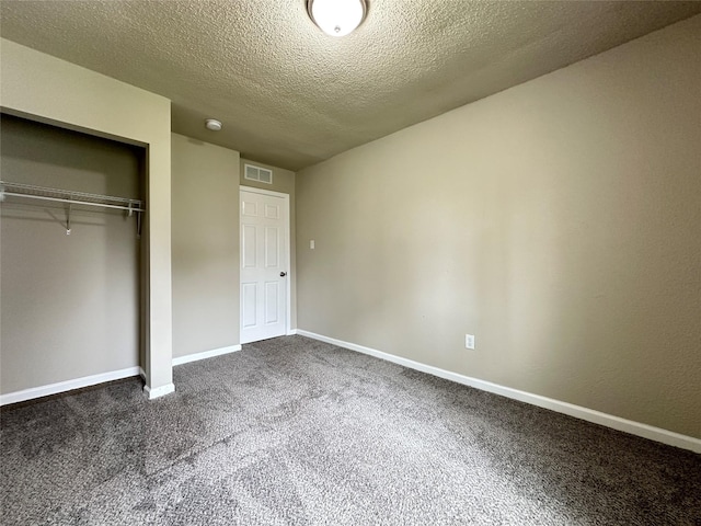 unfurnished bedroom featuring carpet floors, baseboards, visible vents, and a closet