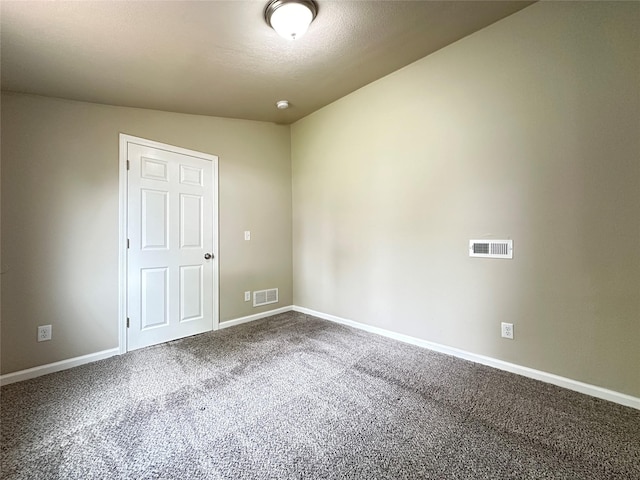 unfurnished room with visible vents, carpet, and baseboards
