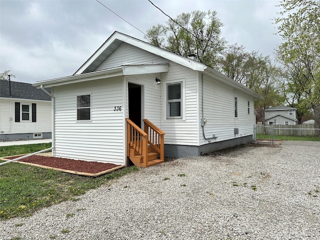 view of front of home featuring fence, driveway, and entry steps