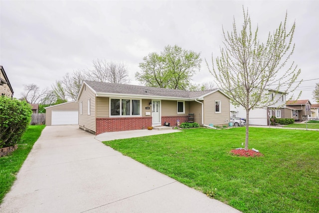 ranch-style house featuring brick siding, an outbuilding, a front yard, and a detached garage