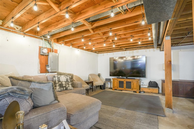 living area with rail lighting, concrete flooring, and electric panel