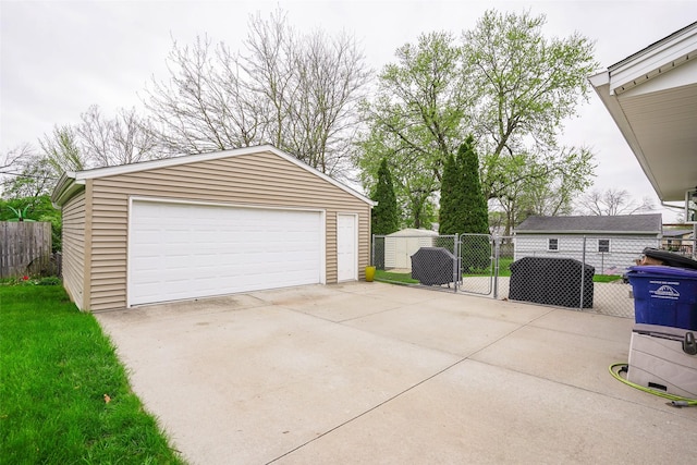 detached garage with a gate and fence