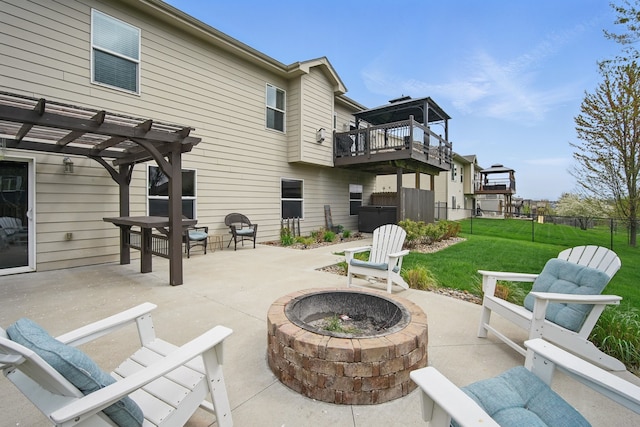 view of patio / terrace featuring a pergola, fence, and a fire pit