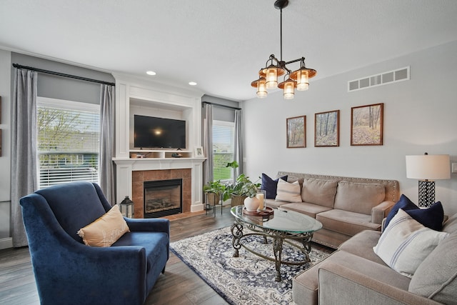 4474 NW 165th St, Clive, IA 50325 - living area with wood finished floors, a fireplace, recessed lighting, and a chandelier