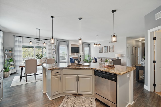 kitchen featuring stainless steel dishwasher, dark wood finished floors, and a sink