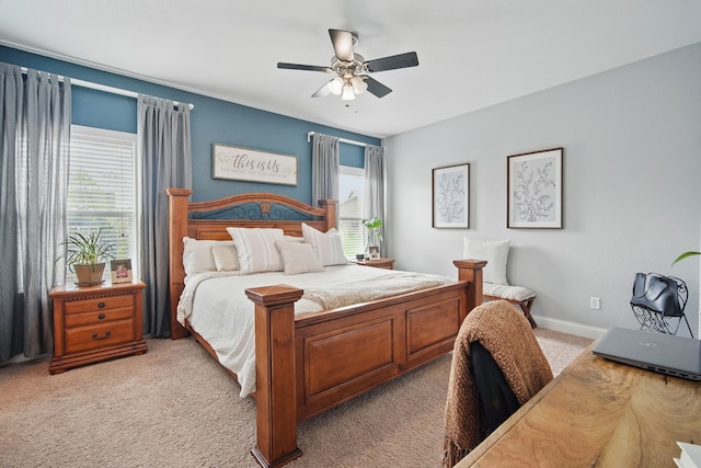 bedroom with a ceiling fan, baseboards, and light carpet
