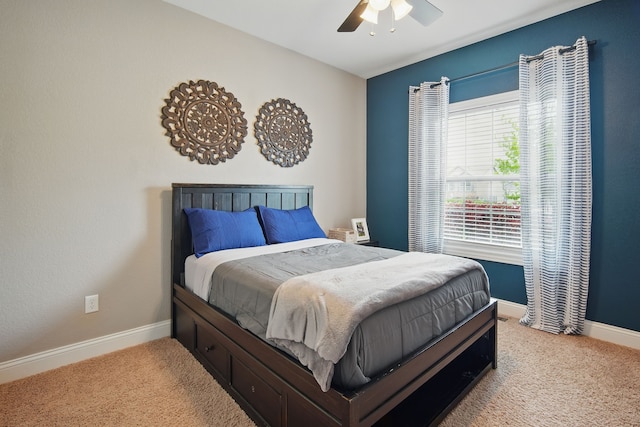 bedroom with a ceiling fan, baseboards, and carpet