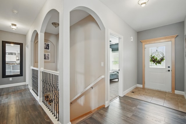 entrance foyer with baseboards and wood finished floors