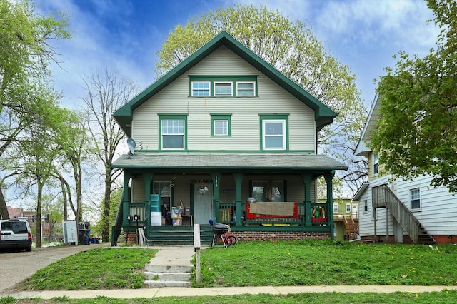 view of front of property featuring a porch and a front lawn