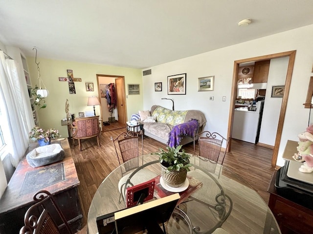 dining space featuring visible vents and wood finished floors