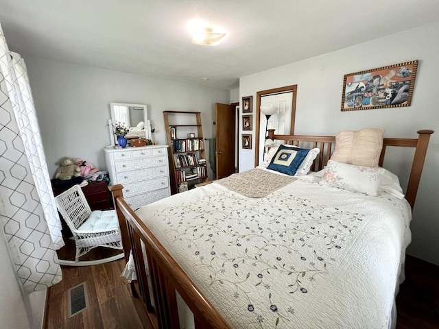 bedroom with visible vents and dark wood-style floors