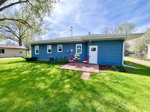 rear view of house featuring a lawn, a patio, and cooling unit