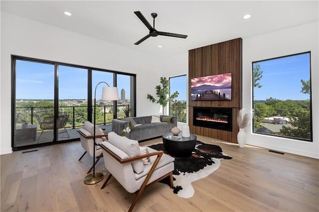 508 Indianola Rd Unit 1, Des Moines, IA 50315 - living area with recessed lighting, a fireplace, light wood-type flooring, and visible vents